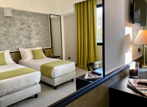 Postel nebo postele na pokoji v ubytování Hotel Gardenia Fiera