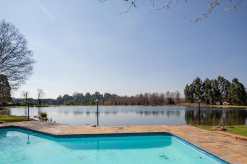 a swimming pool next to a large lake at Critchley Hackle in Dullstroom