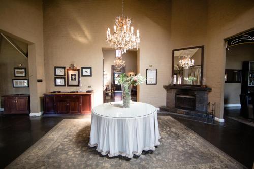 a room with a table with a vase of flowers on it at Critchley Hackle in Dullstroom