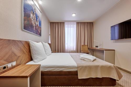 Posteľ alebo postele v izbe v ubytovaní Tourist Hotel