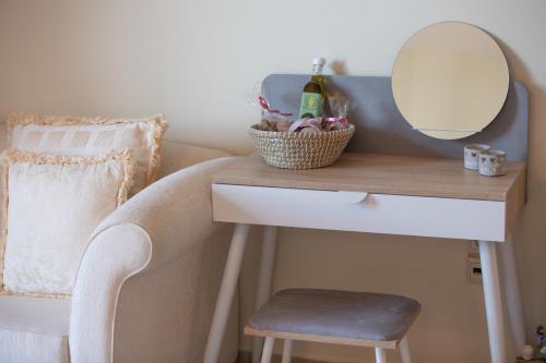 a dressing table with a mirror and a chair at il giardino in Minia