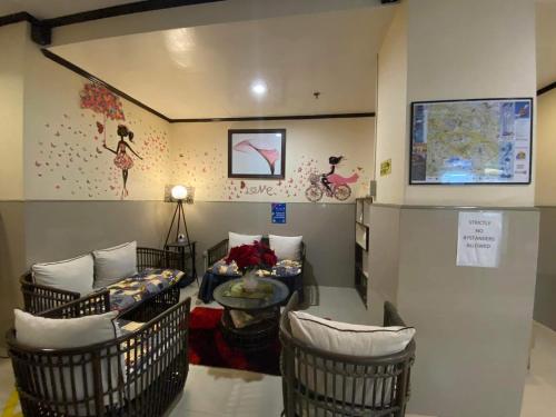 a room with chairs and a couch and a table at Amax Inn Makati in Manila