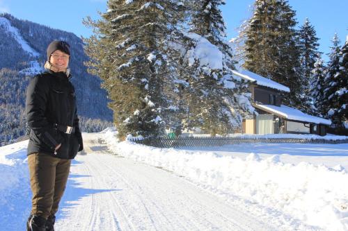 a woman walking down a snow covered road at Urlaub am Bio-Bauernhof Liebchen in Zeutschach