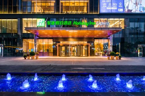 a building with a fountain in front of it at Holiday Inn Express Foshan Beijiao by IHG in Shunde