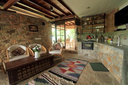 a large living room with a stone wall at Lands End Kandy in Kandy