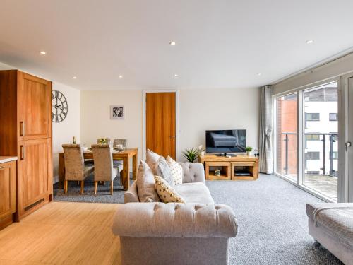 a living room with a couch and a table at Swansea Marina - Sleeps 4 - Underground parking in Swansea