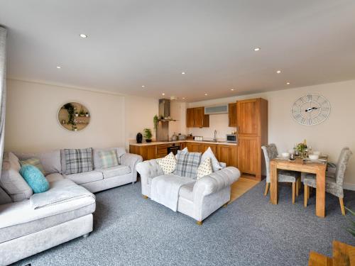 a living room with two couches and a kitchen at Swansea Marina - Sleeps 4 - Underground parking in Swansea