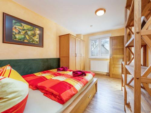 a bedroom with a bed and a bunk ladder at Ferienwohnung Lotse in Schaprode