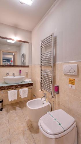 a bathroom with a toilet and a sink at Hotel Fiera Di Brescia in Brescia