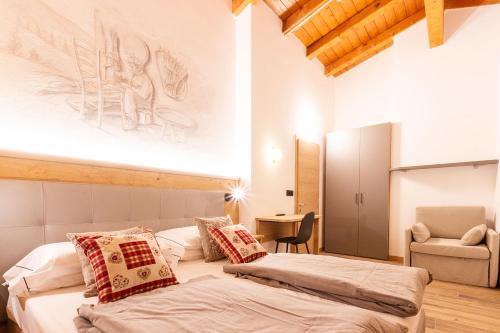 Ένα ή περισσότερα κρεβάτια σε δωμάτιο στο Residence Hotel Santa Maria piscina e wellness