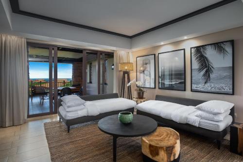 a living room with a couch and a table at The Capital Zimbali in Ballito