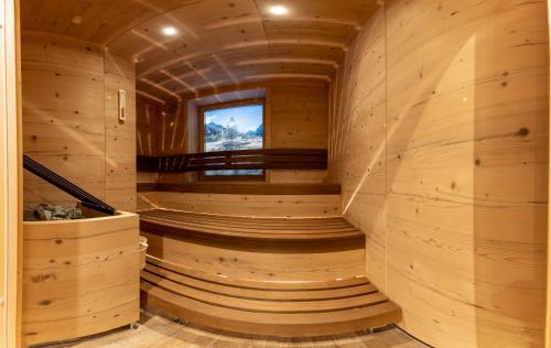 a sauna in a wooden cabin with a window at Sport Apart in Zell am Ziller