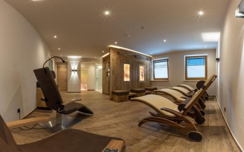 a salon with a row of chairs in a room at Sport Apart in Zell am Ziller