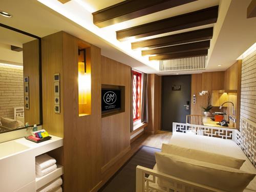 a room with a bed and a dining room at AMOY by Far East Hospitality in Singapore