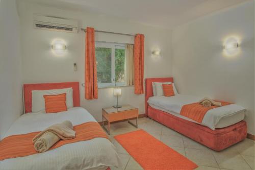a bedroom with two beds and a window at Casa Monte Cristo Apartments - Orange in Lagos