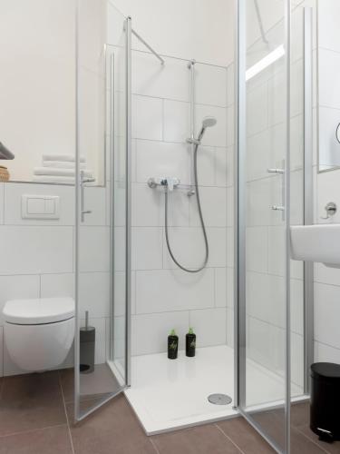 a shower with a glass door in a bathroom at Limehome Trier Nikolaus-Leis-Straße in Trier