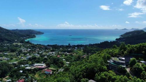 an aerial view of a town and the ocean at Residence Monte-Cristo in Anse Boileau