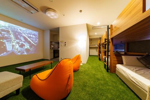 een kamer met een bed, een bank en een tv bij STAY & GO Shinsaibashi-Kita in Osaka