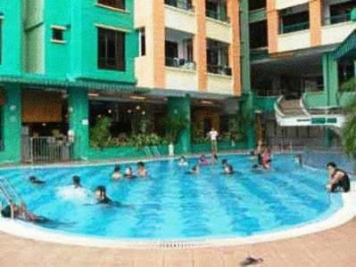 a group of people in a large swimming pool at Marina Cove Resort in Lumut
