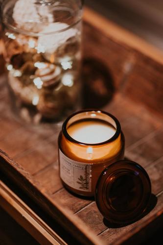 a candle sitting on top of a wooden table at Gîtes du Bulz, en pleine forêt proche de la mer in Pleyber-Christ