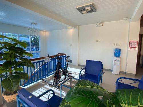 a waiting room with two blue chairs and a plant at Hip Nautic Beach Resort powered by Cocotel in Lian