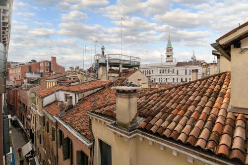 a view of roofs of buildings in a city at San Marco Schiavoni apartments in Venice