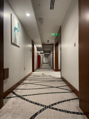 a long hallway with a carpet on the floor at Grand Tourist Hotel in Muscat