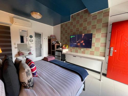 a bedroom with a bed and a flat screen tv at Italy Condotel Darasa in Tanauan