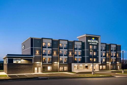 a hotel with a sign on the front of it at Microtel Inn & Suites by Wyndham Antigonish in Antigonish