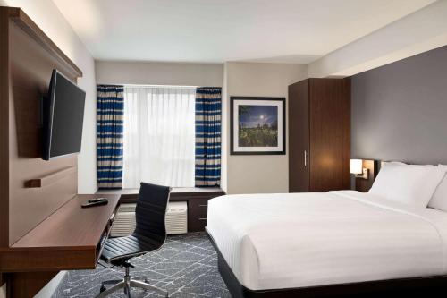 a hotel room with a bed and a desk with a computer at Microtel Inn & Suites by Wyndham Antigonish in Antigonish