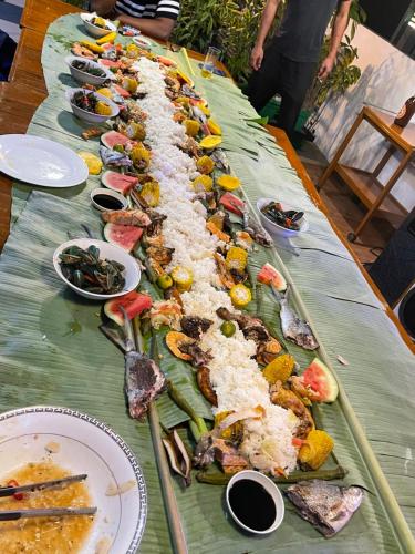 a long table with many different types of food on it at Italy Condotel Darasa in Tanauan