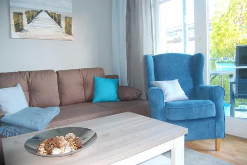 ein Wohnzimmer mit einem Sofa und einem Tisch in der Unterkunft Haus Jahreszeiten Appartement Meeresrauscher by Unsere Urlaubszeit in Binz