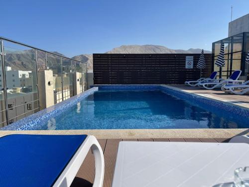 a swimming pool on top of a building at Grand Tourist Hotel in Muscat