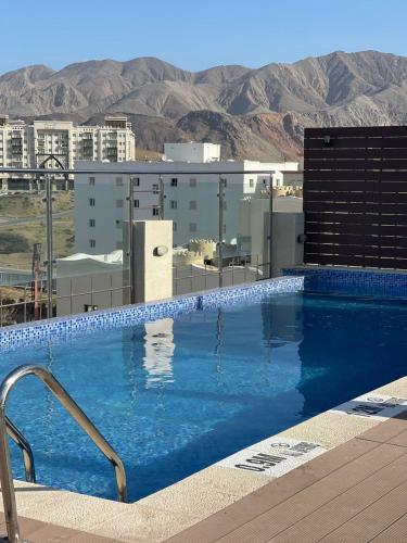 a large swimming pool on top of a building at Grand Tourist Hotel in Muscat
