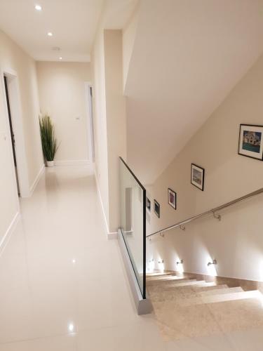 a staircase in a house with white walls and white floors at Villa Olive Hill in Tučepi