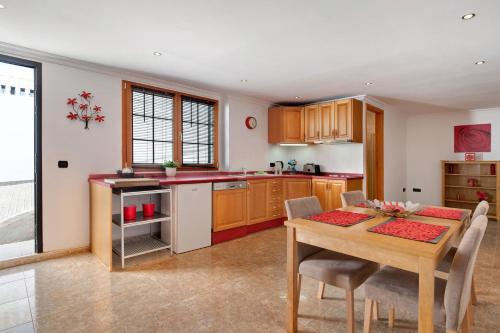 a kitchen with a table and a dining room at Villa Carolina in Tías
