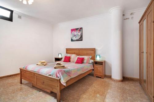 a bedroom with a bed with red pillows on it at Villa Carolina in Tías
