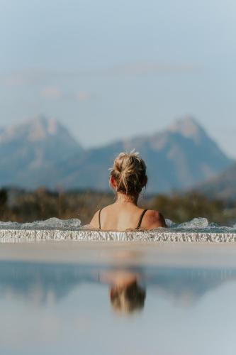 a woman sitting in a pool of water at Hotel Sperlhof in Windischgarsten