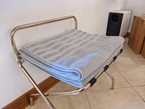 a bed with a blue blanket on top of it at Casa Monte Cristo Apartments - Almond in Lagos