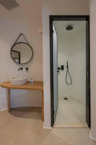 a bathroom with a sink and a mirror at Argo Hotel in Platis Yialos Mykonos