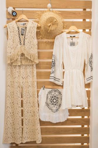 a rack of dresses and skirts on a wall at Argo Hotel in Platis Yialos Mykonos