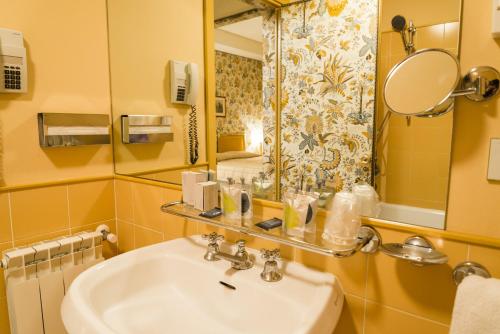 a bathroom with a sink and a mirror at Hotel Villa La Principessa in Lucca