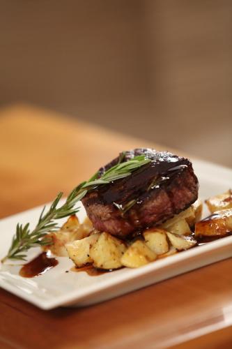 a plate of food with a piece of meat and potatoes at Berri Hotel in Berri