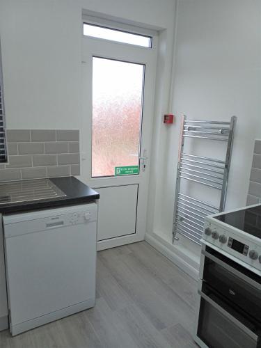 a kitchen with a window and a counter top at St Annes Lodge Apartments, Lytham St Annes in Lytham St Annes