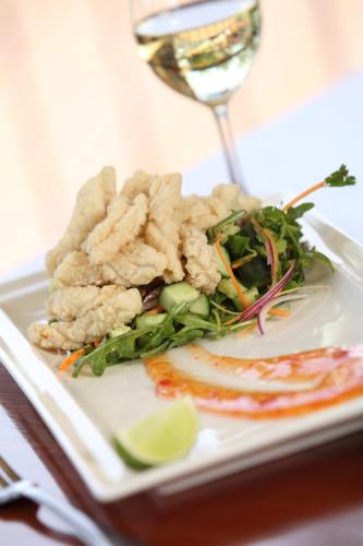 a plate of food on a table with a glass of wine at Berri Hotel in Berri