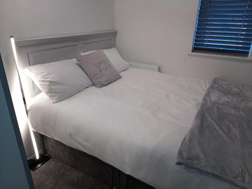 a bed with two pillows on it in a bedroom at St Annes Lodge Apartments, Lytham St Annes in Lytham St Annes