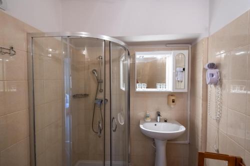 a bathroom with a shower and a sink at Fényes Vinorium in Sopron