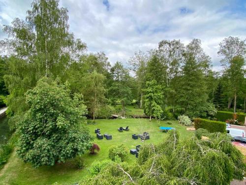 an aerial view of a park with chairs in the grass at Le Moulin Fouret in Saint-Aubin-le-Vertueux