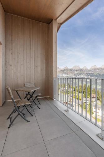 a balcony with a table and chairs and a view at Ferienwohnungen Tannenboden in Flumserberg