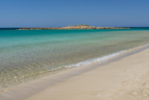 a sandy beach with a blue sky at Capo Bay Hotel in Protaras
